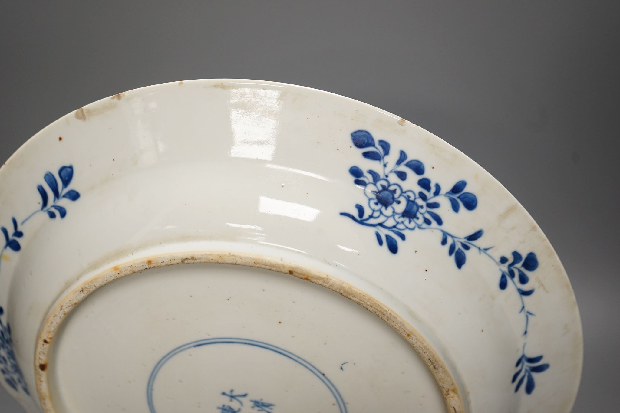 A Chinese blue and white landscape dish, Kangxi mark but 19th century, 36cm